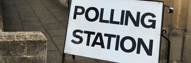 Polling station sign outside of building