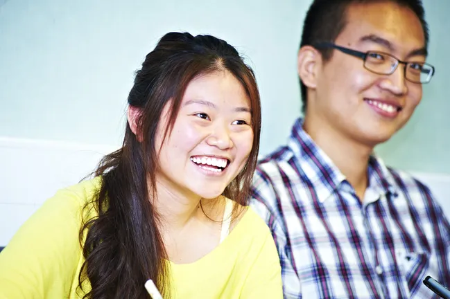 Two students laughing