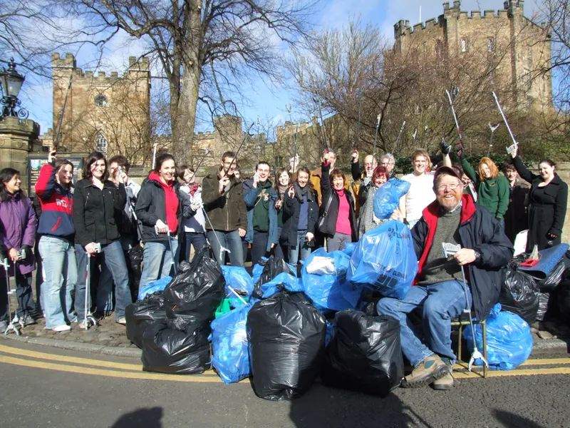 Group litter picking in front of Durham Castle with Bill Bryson