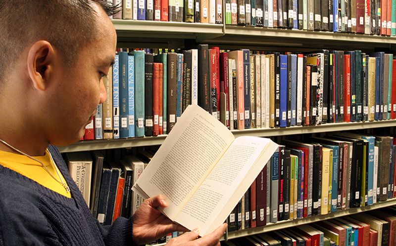 A research student Reading a book in Bill Bryson Library