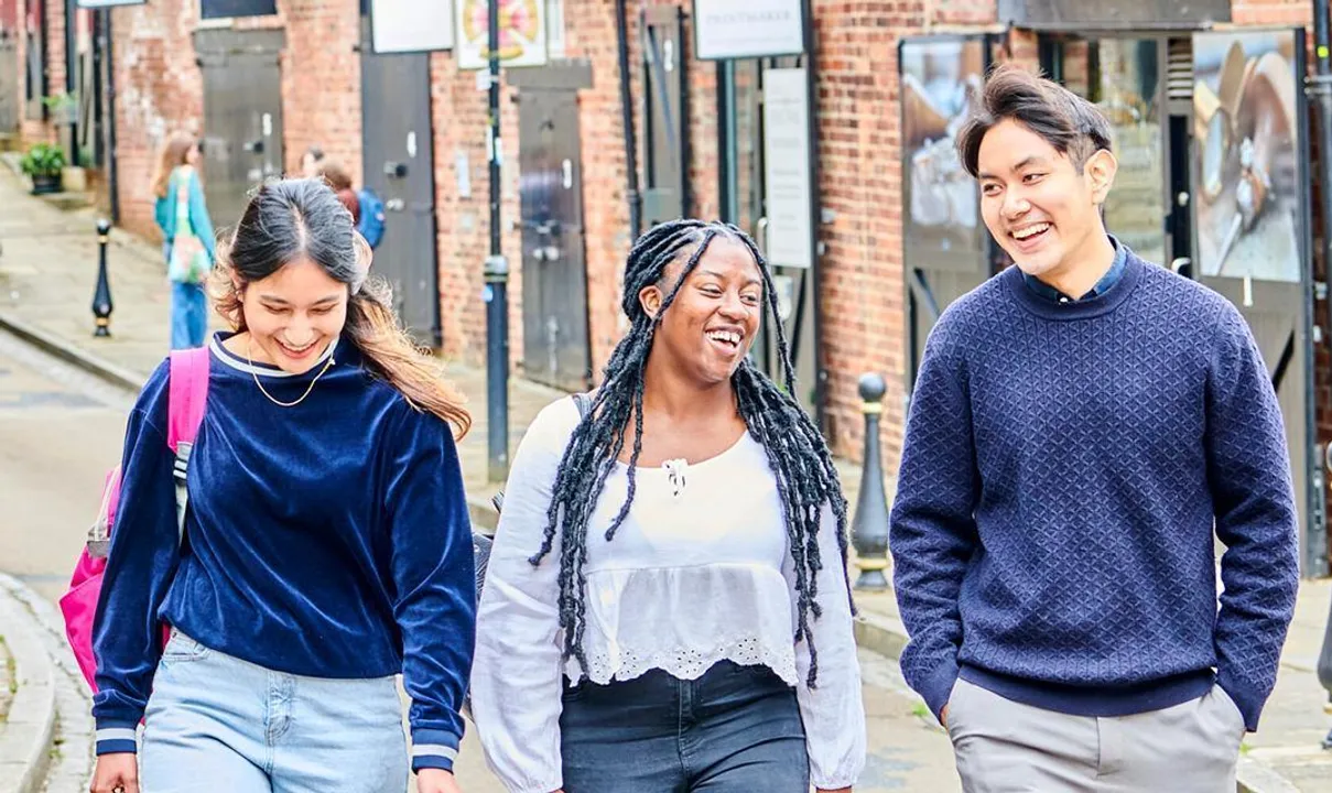 Student chatting with Durham and the Cathedral in the background