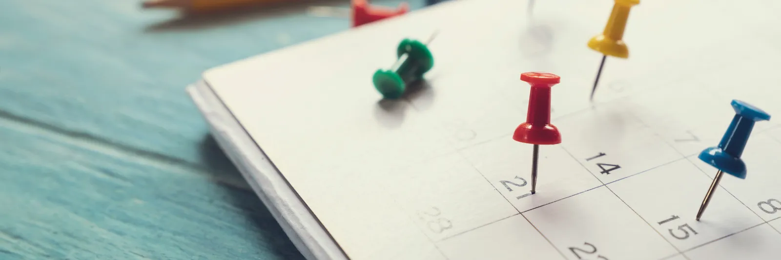 Coloured pins on a paper calendar