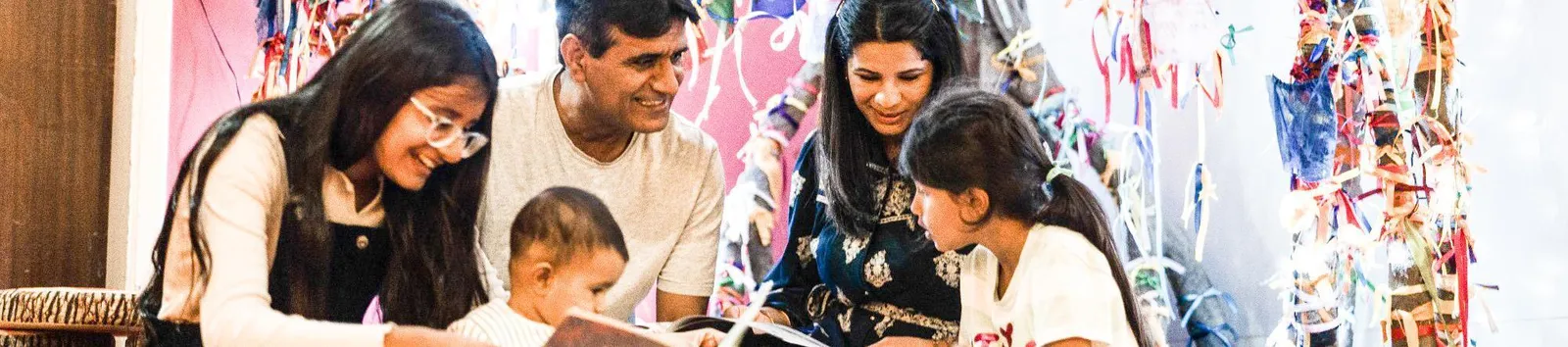 A family sitting together reading