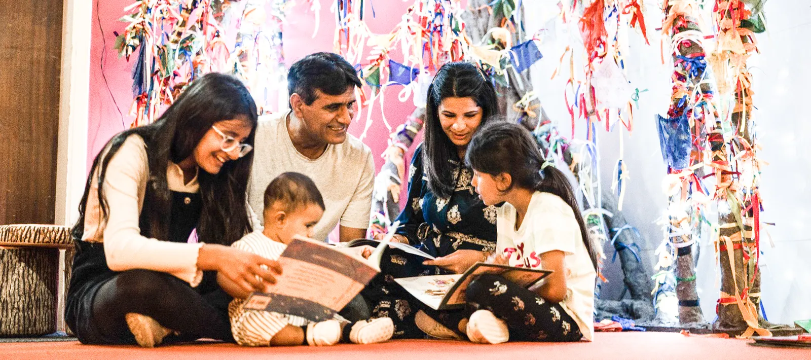A family sitting together reading