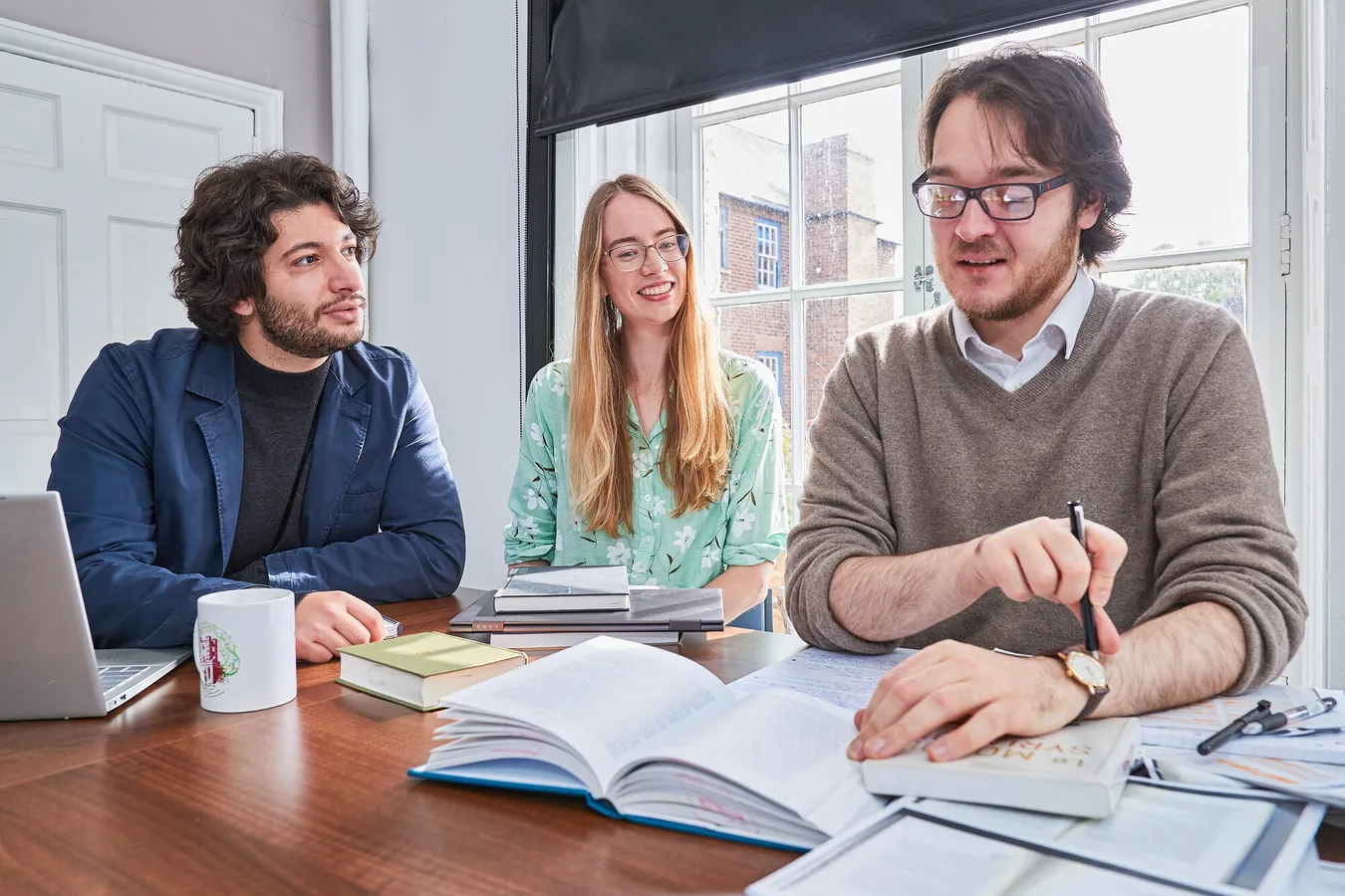 Three people looking over notes
