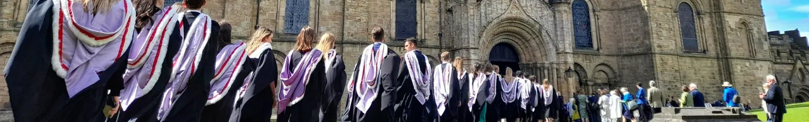 Students in gowns entering Durham Cathedral