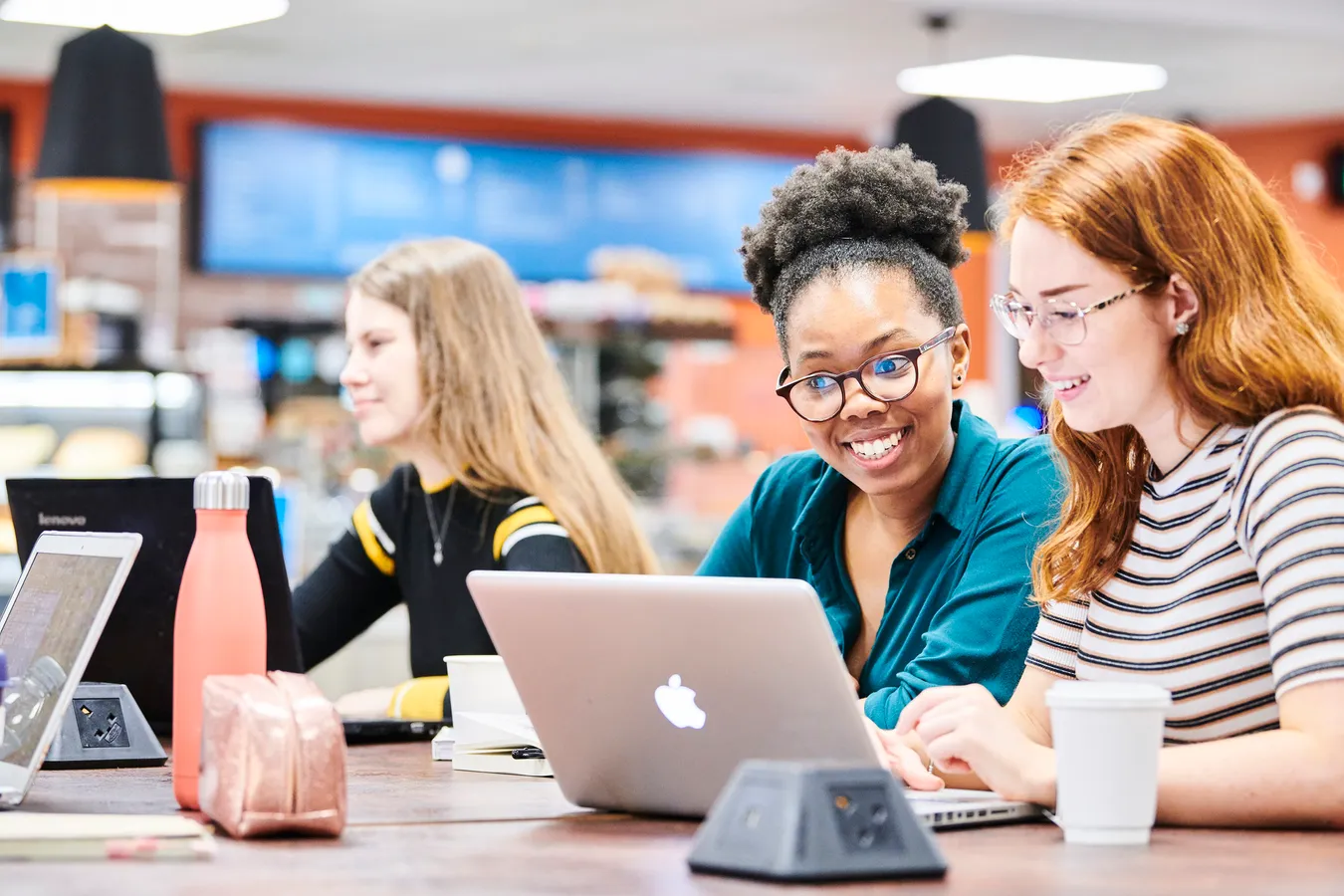 Students working on laptop in Bill Bryson Library café