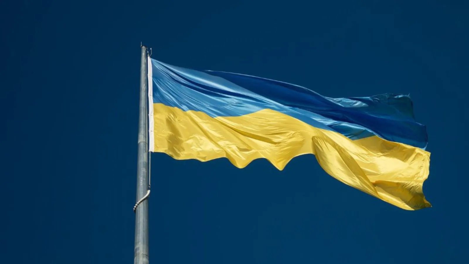 Ukraine flag flying against a blue sky