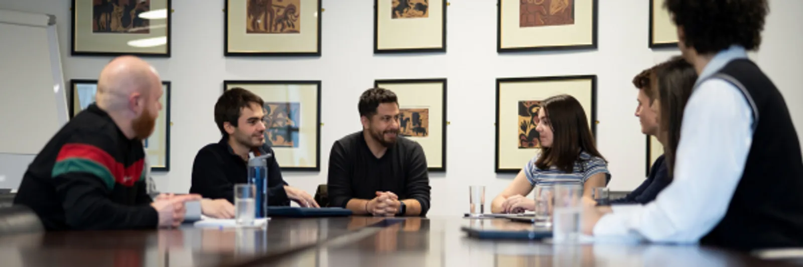 Staff from the International, Engagement & Careers team along with an academic sit at a round boardoom style table