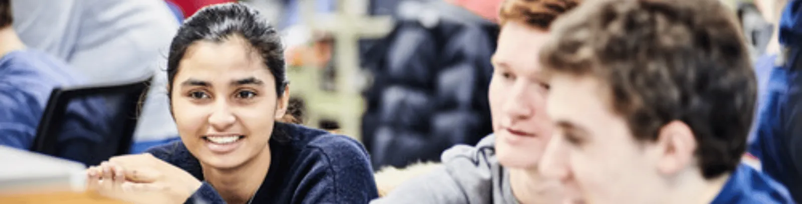 Three students looking at computer screens