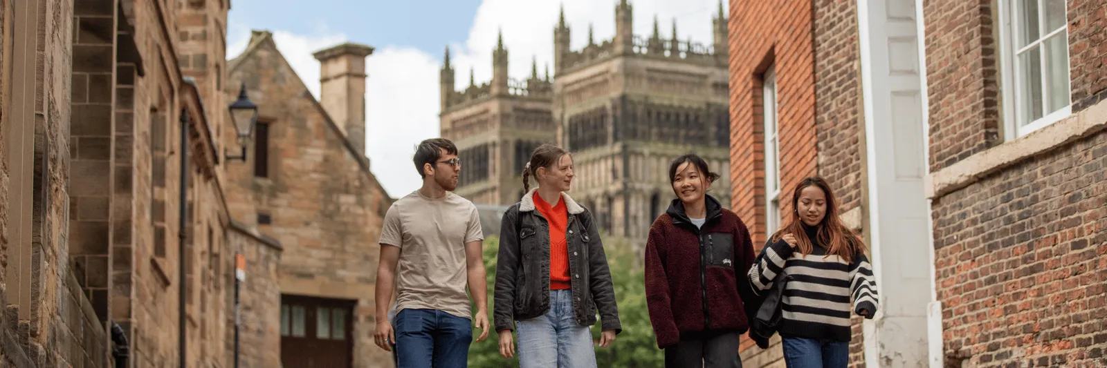 Students walking with Durham Cathedral in the background