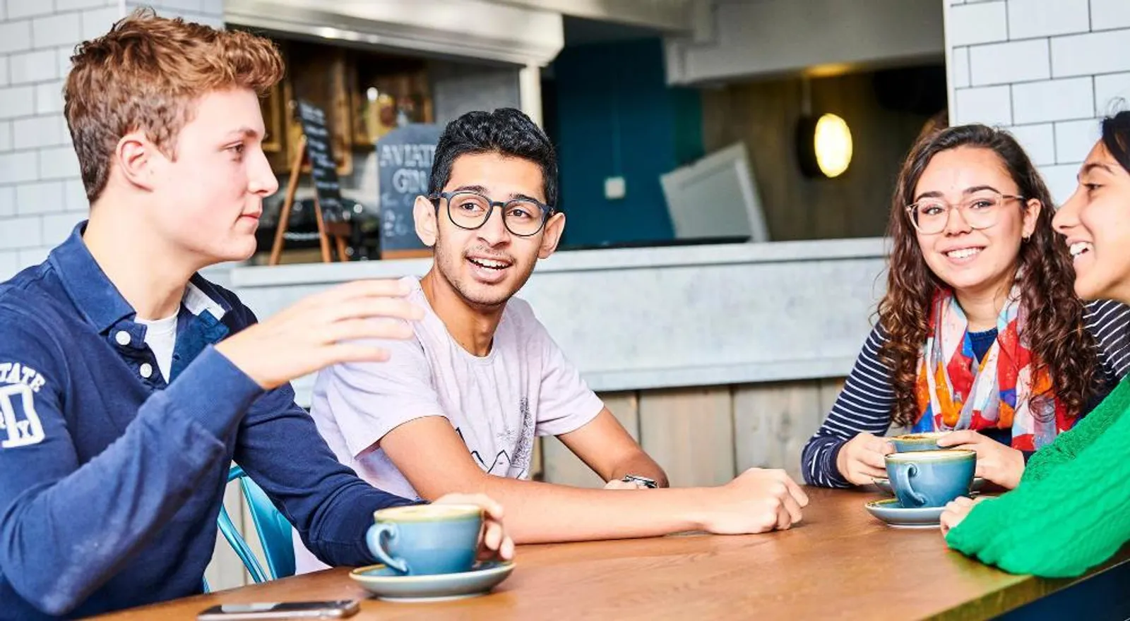 Students in a cafe drinking coffee