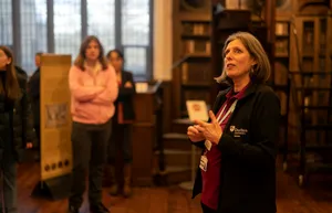 Image of a tour guide explainging the history of Bishop Cosin's library to a group