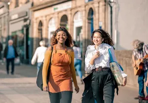 Two women in walking through Durham city centre