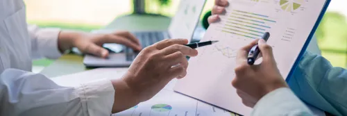 Reviewing sustainability reports in business meeting