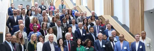 Photograph of DBA Conference attendees gathered on the main staircase at Waterside