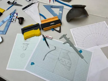 Photography of a table with an artefact being illustrated