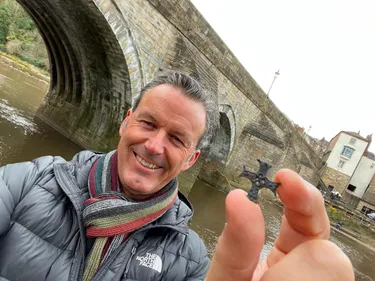 Picture of Gary Bankhead in front of Elvet Bridge holding an object