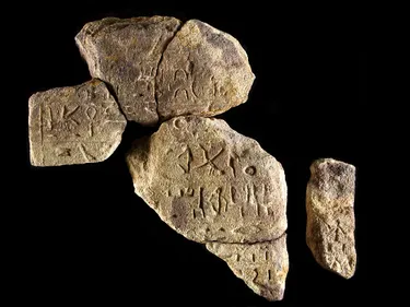 A group of stone fragments with hieroglyphs carved into them