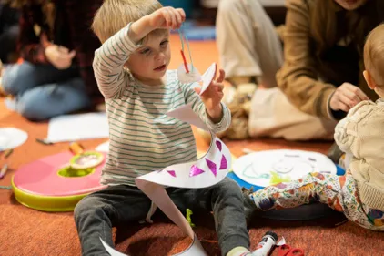 Child with paper snake