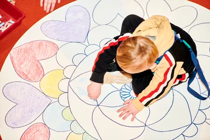 Child colouring in mandala pattern