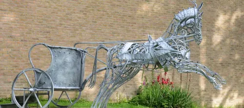 Metal sculpture of a horse and chariot