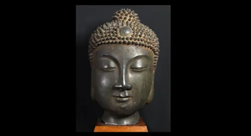 Buddha, head, walnut plinth and bracket.