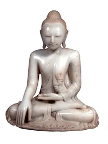 Image of white marble buddha, sat cross legged and meditating with one hand in his lap and the other touching the floor. His eyes are closed.