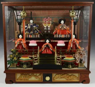 A Hina Matsuri set of ornamental dolls (hina-ningyō). A special seven tiered platform or altar (hina dan) covered with red carpet is used to display the dolls, who are wearing traditional court dress of the Heian period (794 and 1185), when the custom of displaying dolls began.