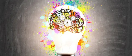 A glowing multi coloured brain inside a lightbulb