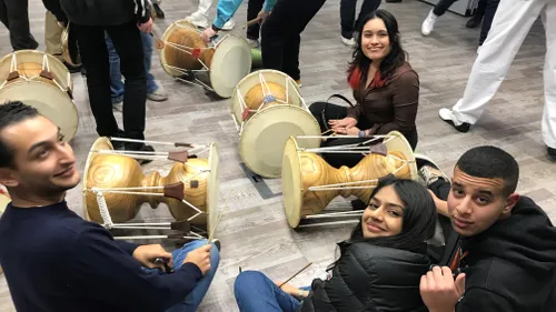 A group of international students playing African drums