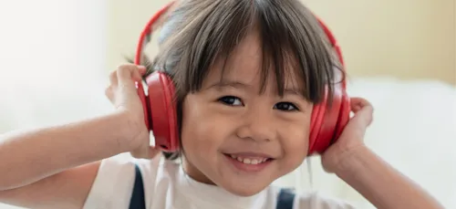 Child listening to music on headphones