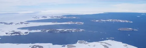 A snow and ice landscape next to the sea