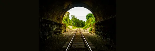 View looking through an old brick railway tunnel.