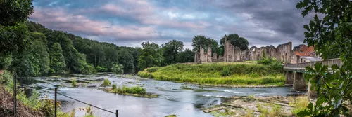 River Wear in the foreground flowing past the remains of Finchale Priory in County Durham