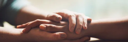 A close up of people holding hands