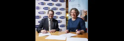 Durham County Council Chief Executive John Hewitt and Durham University Vice-Chancellor Professor Karen O'Brien seated at a table, signing the refreshed Memorandum of Understanding between the two organisations