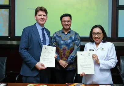 People standing with signed documents