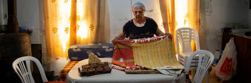An old woman of Kurdistani Jewish heritage folding clothes