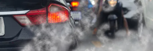 Cars in traffic emitting pollution