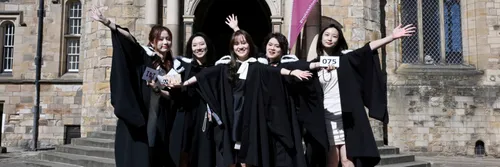 Group of 5 students in front of University College steps