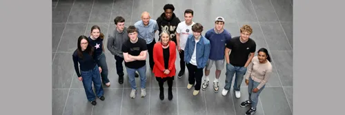 A group of students dressed casually stood with Chancellor Dr Fiona Hill