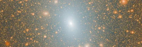 A simulation showing a bright white galaxy at the centre, surrounded by fainter galaxies, against a black backdrop.