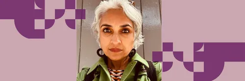 Professor Nayanika Mookherjee wearing a green top looking seriously at the camera