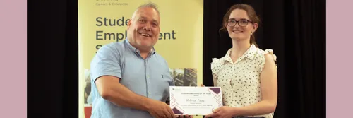 Student receiving award certificate