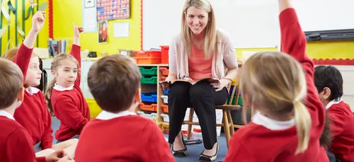 Teacher with pupils sat on the floor
