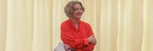 Vice Chancellor Karen O'Brien smiling with her arms folded wearing a red blouse