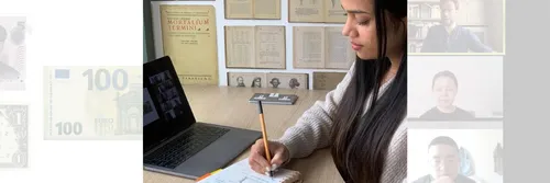 Student writing notes while on a video call