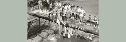 Black and white archive photo of female students on a greasy pole