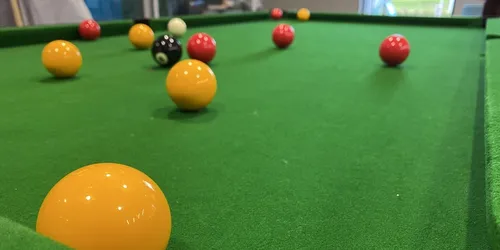 A close up picture of a pool table
